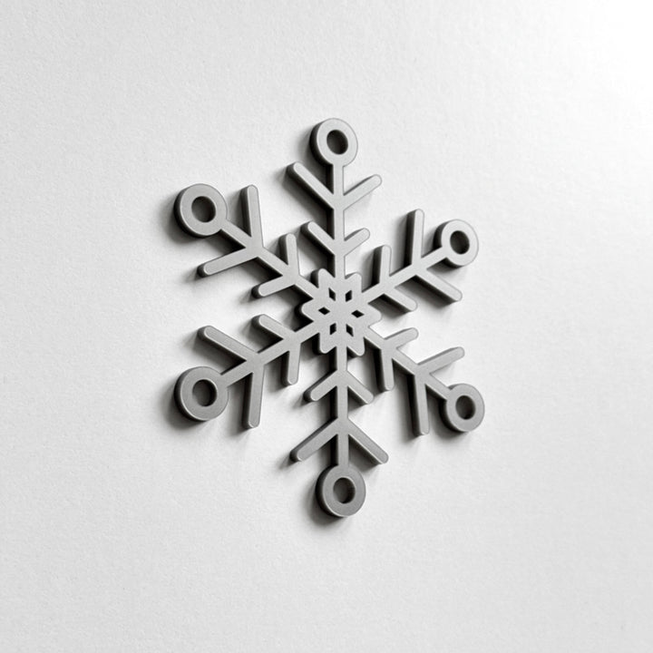A black and white image of a snowflake. A black and white image of a snowflake.