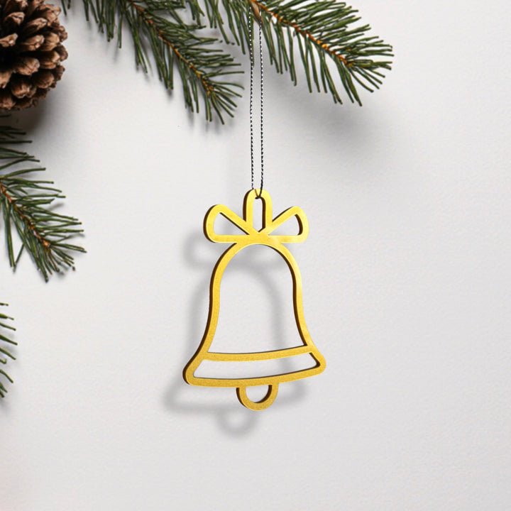 A golden bell ornament hangs from a branch of a pine tree, creating a festive and holiday-themed scene. A golden bell ornament hangs from a branch of a pine tree, creating a festive and holiday-themed scene.