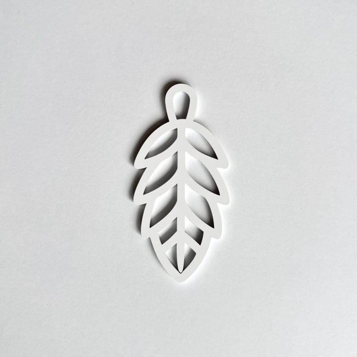 A white leaf-shaped object is shown against a plain white background. A white leaf-shaped object is shown against a plain white background.