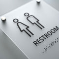 a restroom sign with a man and a woman on it - Photo #6