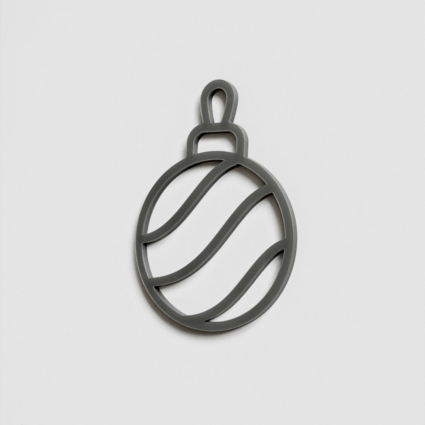 A simple black and white silhouette of a Christmas ornament or ornament-like object.