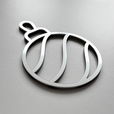A simple, minimalist silver ornament or ornament-like shape is shown against a plain background.