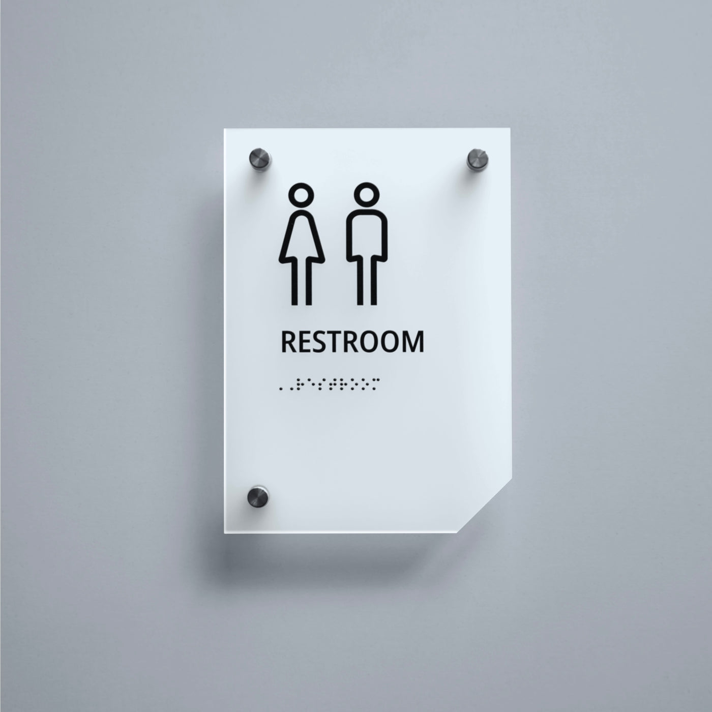 a restroom sign on a gray wall