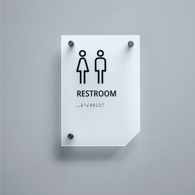 a restroom sign on a gray wall