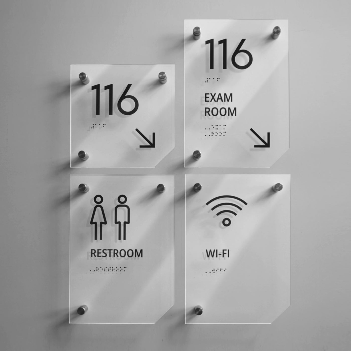 a set of four glass signs on a wall