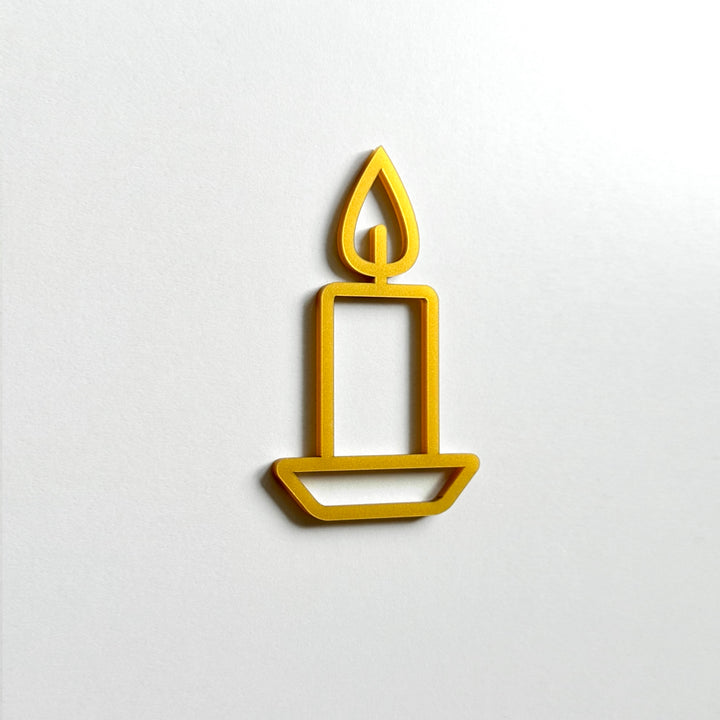 A simple gold candle icon is displayed against a white background.