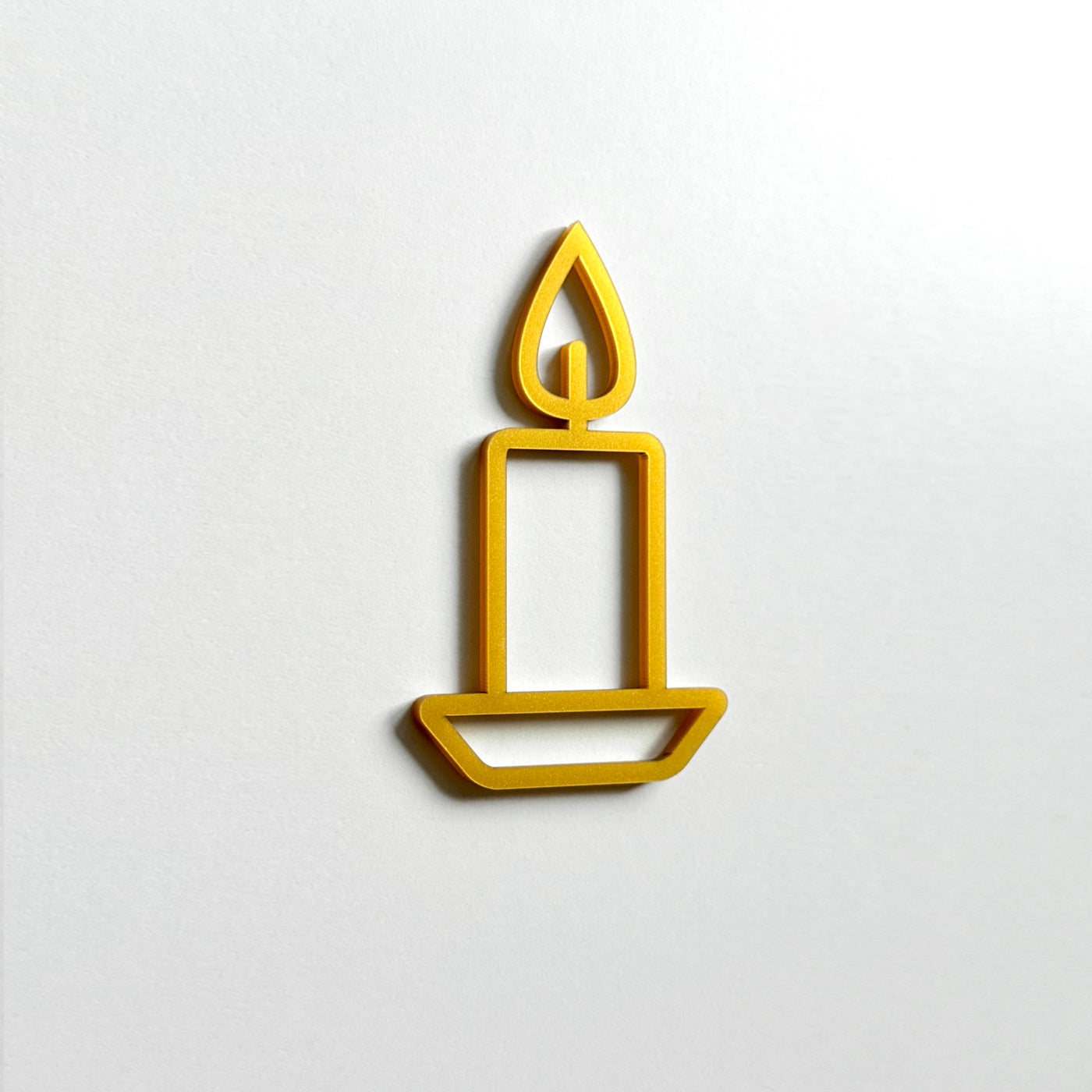 A simple gold candle icon is displayed against a white background.