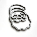 A stylized silhouette of a smiling face, resembling a cartoon or holiday-themed design, is shown against a plain white background. - Photo #9