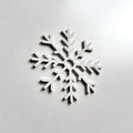 A white snowflake-shaped object is displayed against a plain white background. - Photo #10