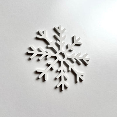 A white snowflake-shaped object is displayed against a plain white background.