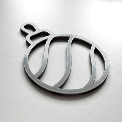 A silver ornament in the shape of a ball with a curved design.