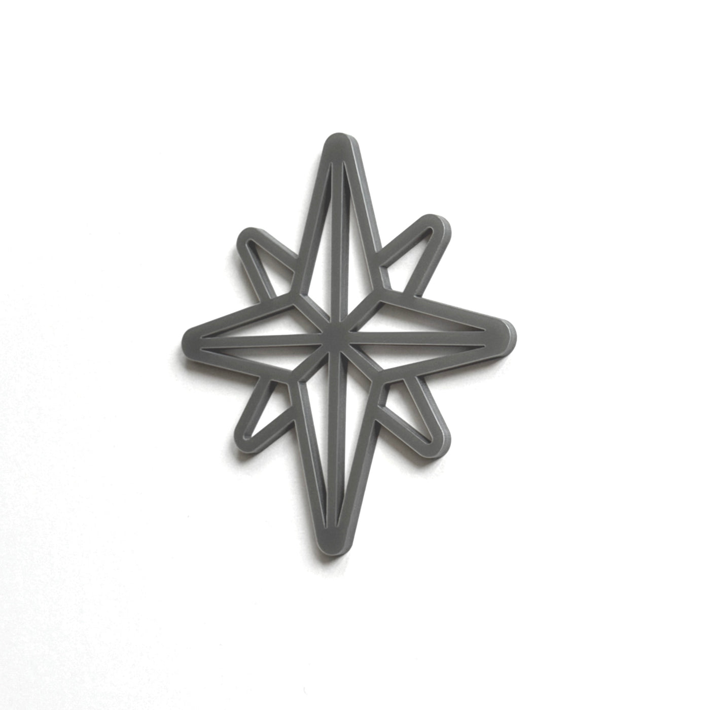 A black star-shaped cutout or stencil is shown against a white background.