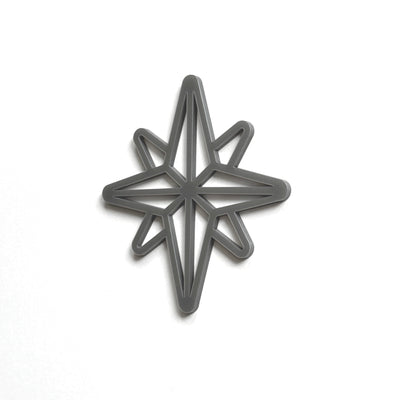 A black star-shaped cutout or stencil is shown against a white background.