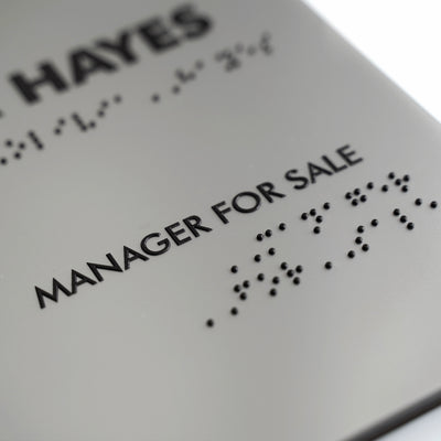 a close up of a sign that says manager for sale