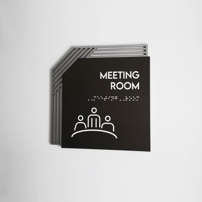 a black and white sign that says meeting room