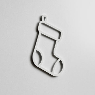 A simple white outline of a stocking on a plain white background.