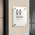 a restroom sign mounted to the side of a building - Photo #9