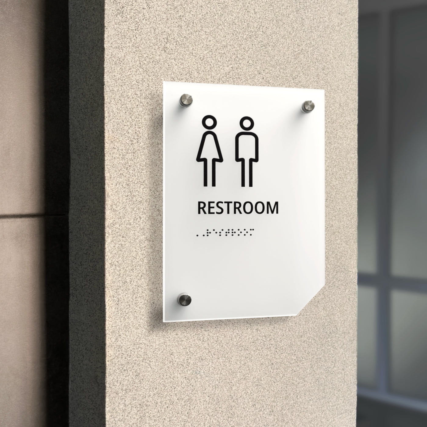 a restroom sign mounted to the side of a building