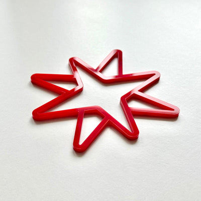 A red star-shaped object is placed on a white surface.