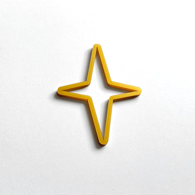 A single, gold-colored star-shaped object is centered against a plain white background.