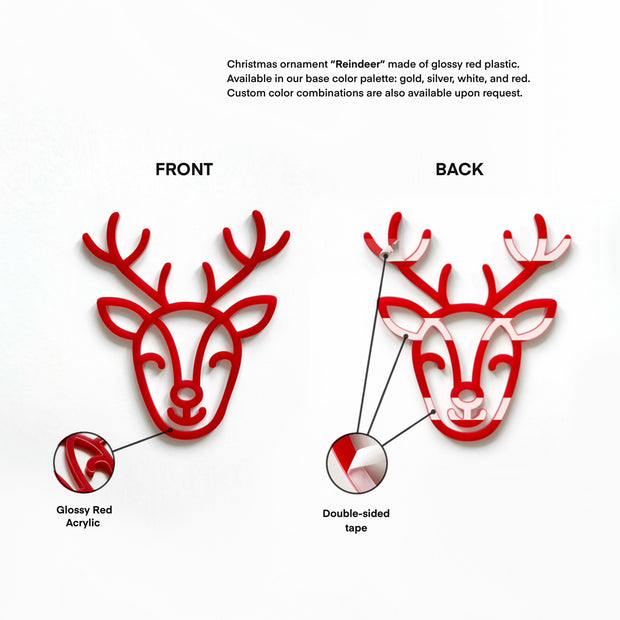 a Christmas ornament in the shape of a reindeer, made of glossy red plastic. The ornament is available in a base color palette of gold, silver, white, and red, and custom color combinations can be requested upon request.