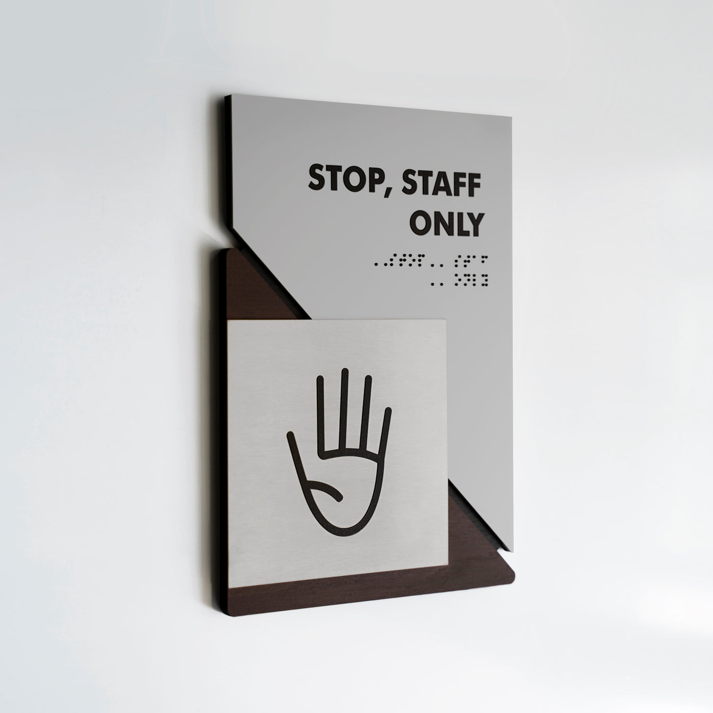 a sign on a wall that says stop, staff only