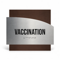 a sign that reads "VACCINATION" with Braille text below it. - Photo #1