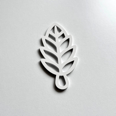 A white leaf-shaped object with a simple, minimalist design.