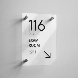 a sign that says exam room hanging on a wall