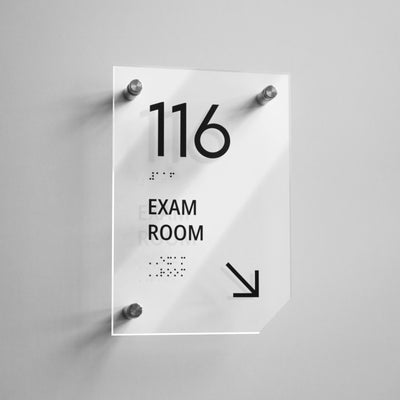 a sign that says exam room hanging on a wall