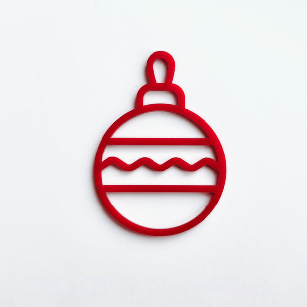 A red Christmas ornament with a wavy pattern on a white background.