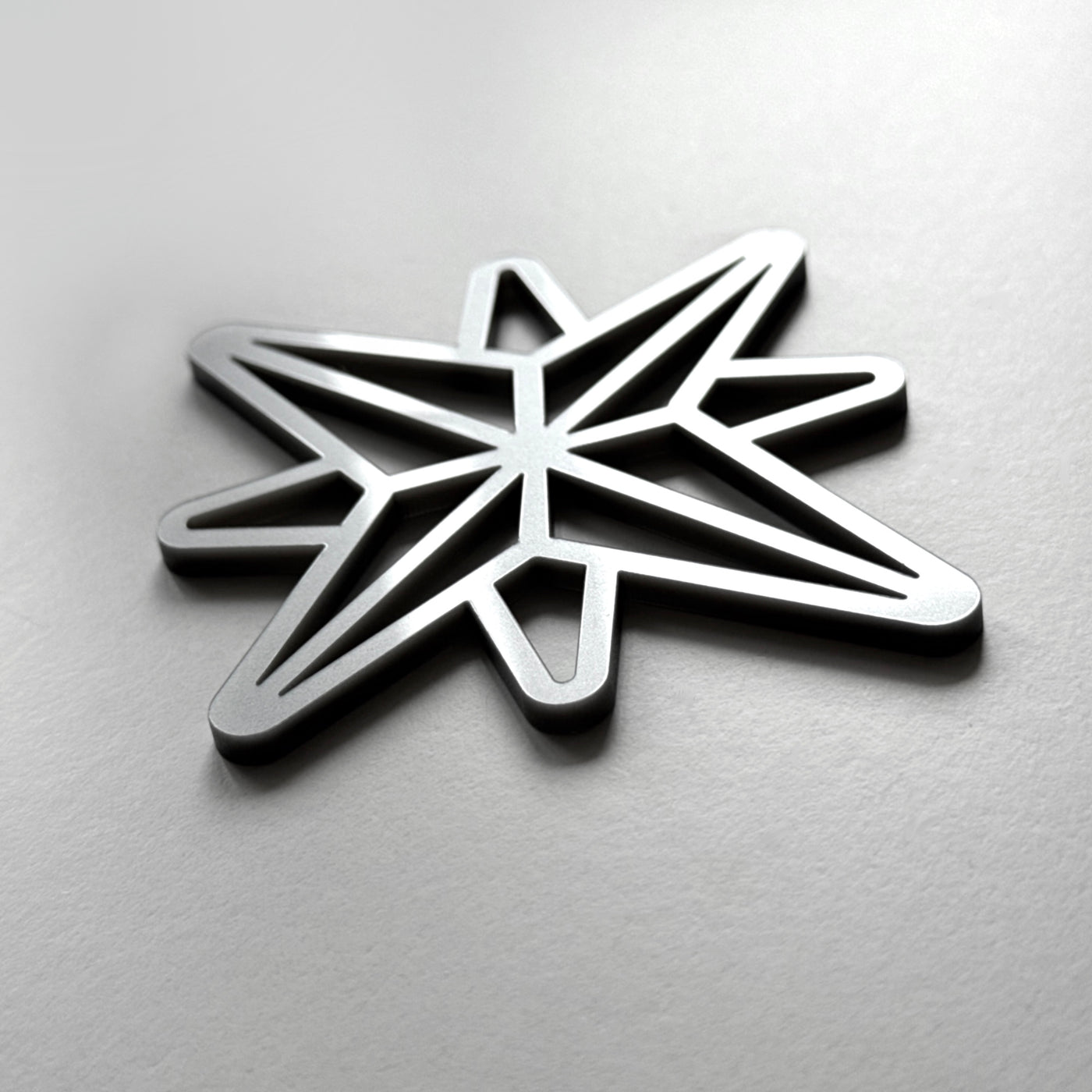 A metallic star-shaped object with a geometric design.