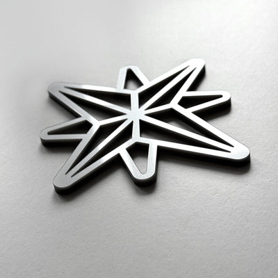 A metallic star-shaped object with a geometric design.