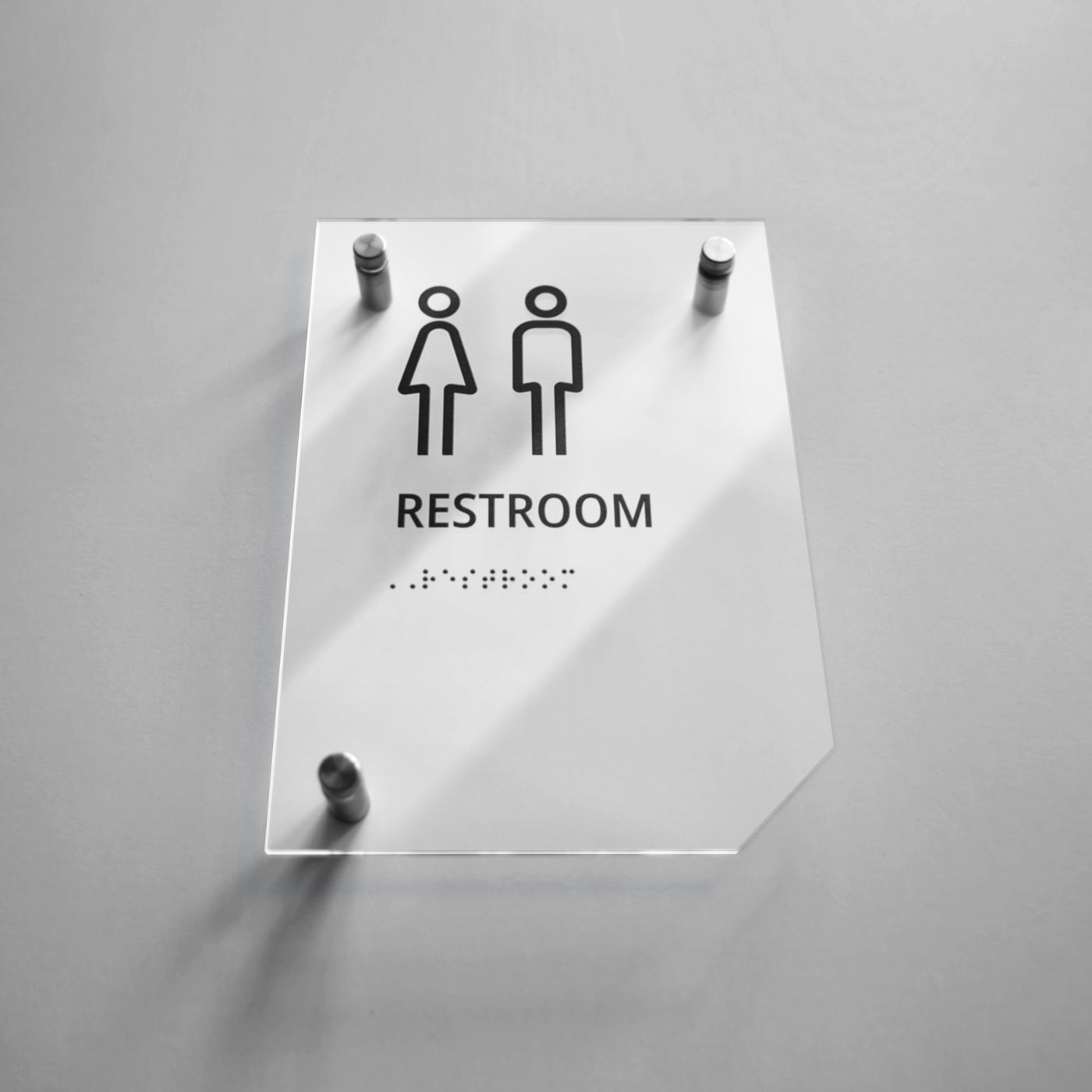 a restroom sign on a white wall