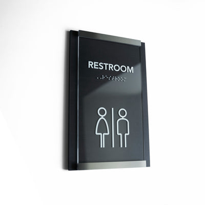a restroom sign on a white wall