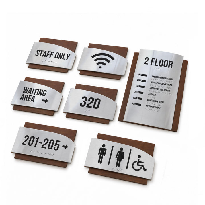 a collection of six metal signs, each with different information and symbols, likely used for directional guidance or accessibility information.