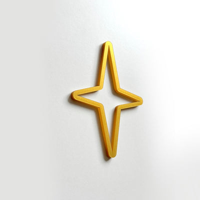 A golden star-shaped object is displayed against a white background.