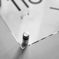 a close up of a glass table with a clock in the background - Photo #7