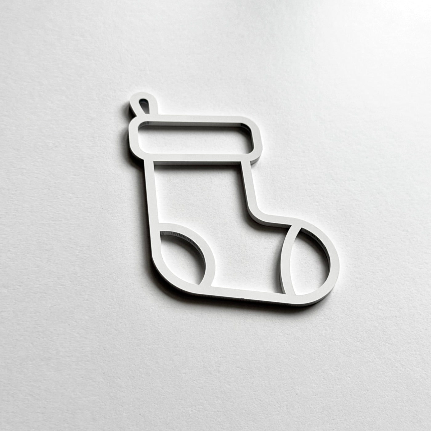 A simple white outline of a stocking on a plain white background.