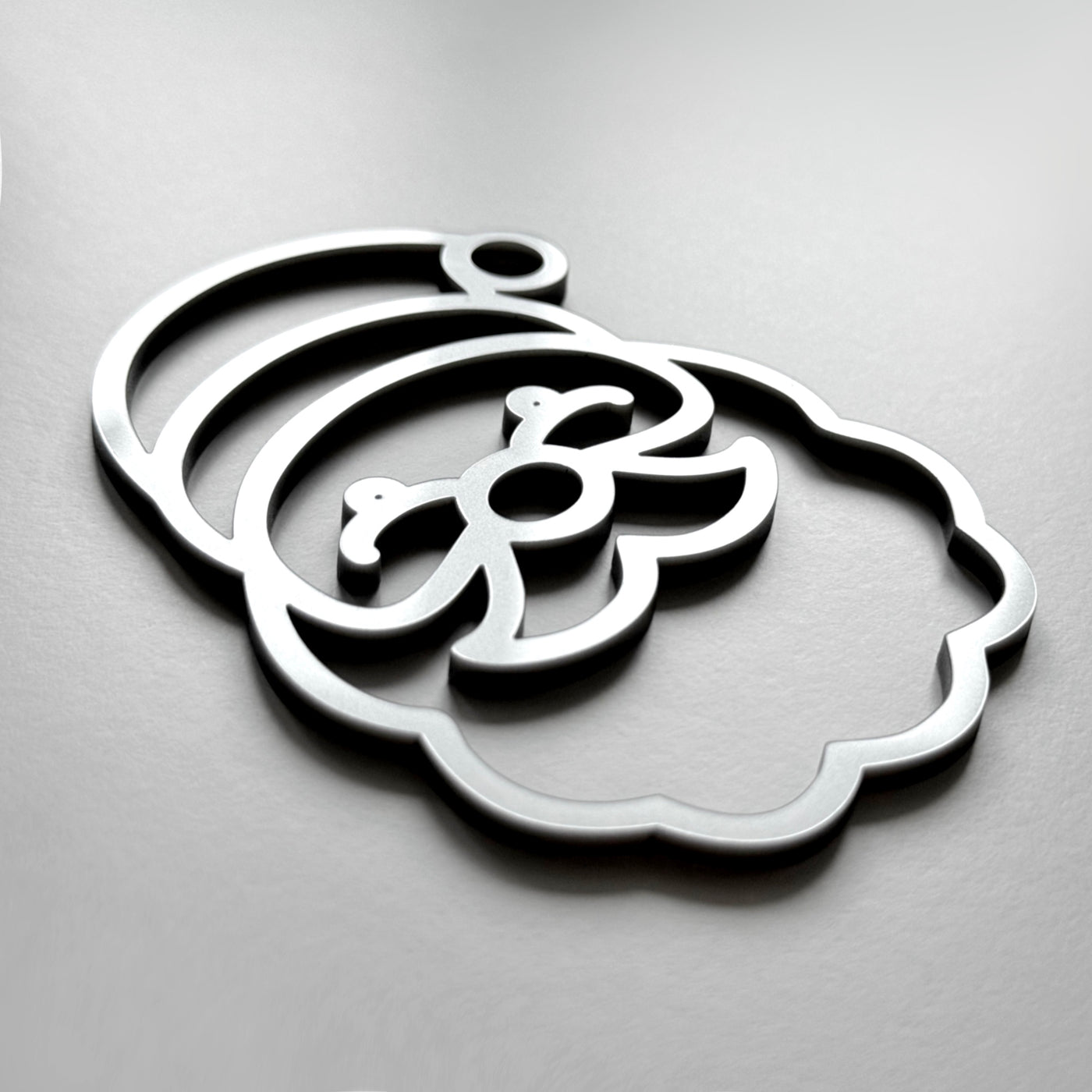 A stylized silhouette of a face or head, resembling a cartoon or abstract design, is shown against a plain background.