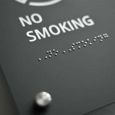 a black and white photo of a sign that says no smoking