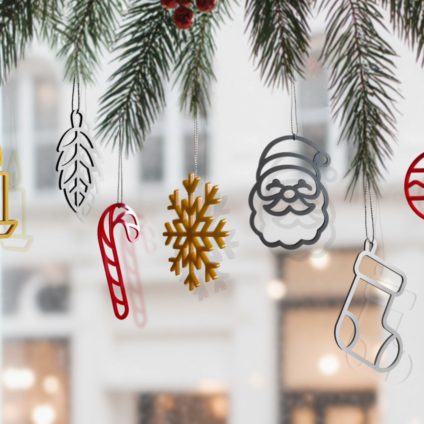 a collection of Christmas ornaments hanging from a tree branch, including a snowflake, a candy cane, a Santa Claus figure, and a stocking.