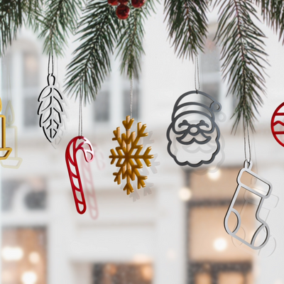 a collection of Christmas ornaments hanging from a tree branch, including a snowflake, a candy cane, a Santa Claus figure, and a stocking.