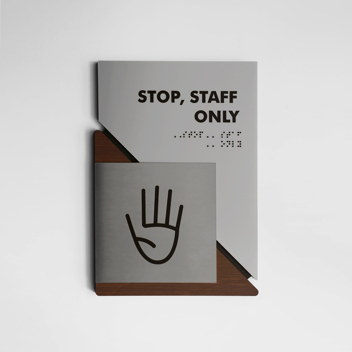 a sign on a wall that says stop, staff only
