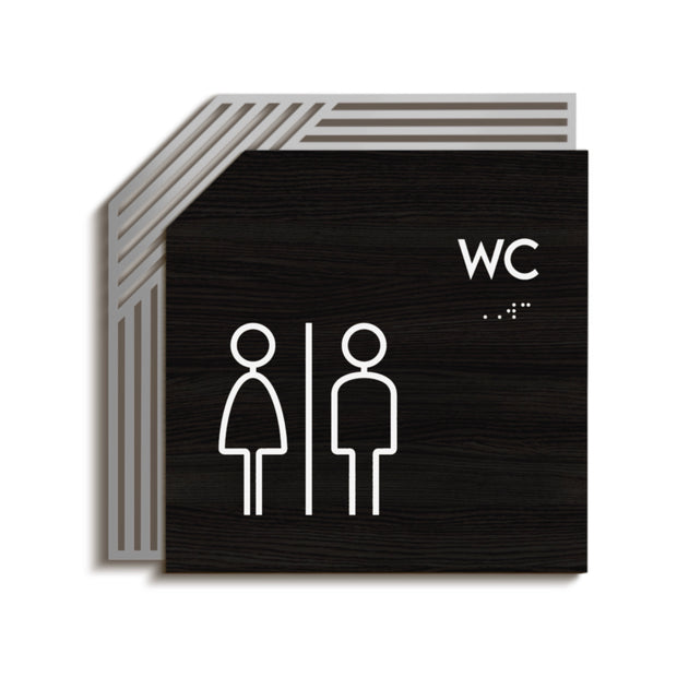 Tactile restroom identification sign with raised characters and Braille beside a restroom entrance