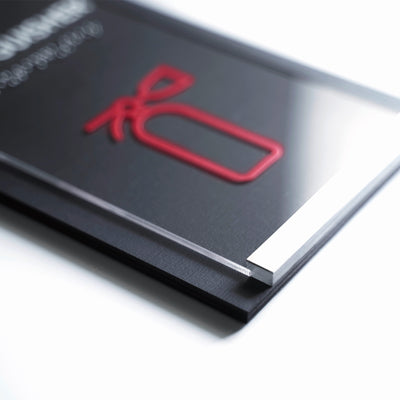 a close up of a book with a red ribbon on it