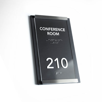 a conference room sign on a white wall