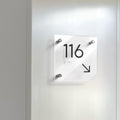 a white clock mounted to the side of a wall - Photo #10