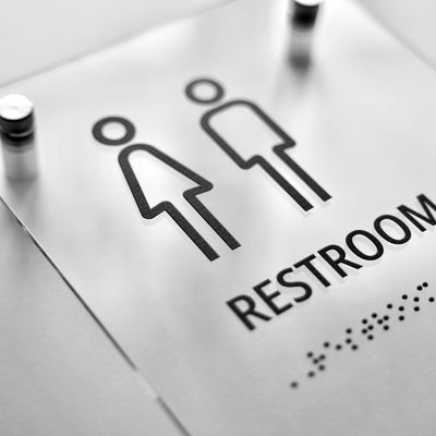 a restroom sign is shown on a table