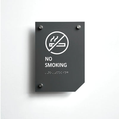 a no smoking sign on a white wall